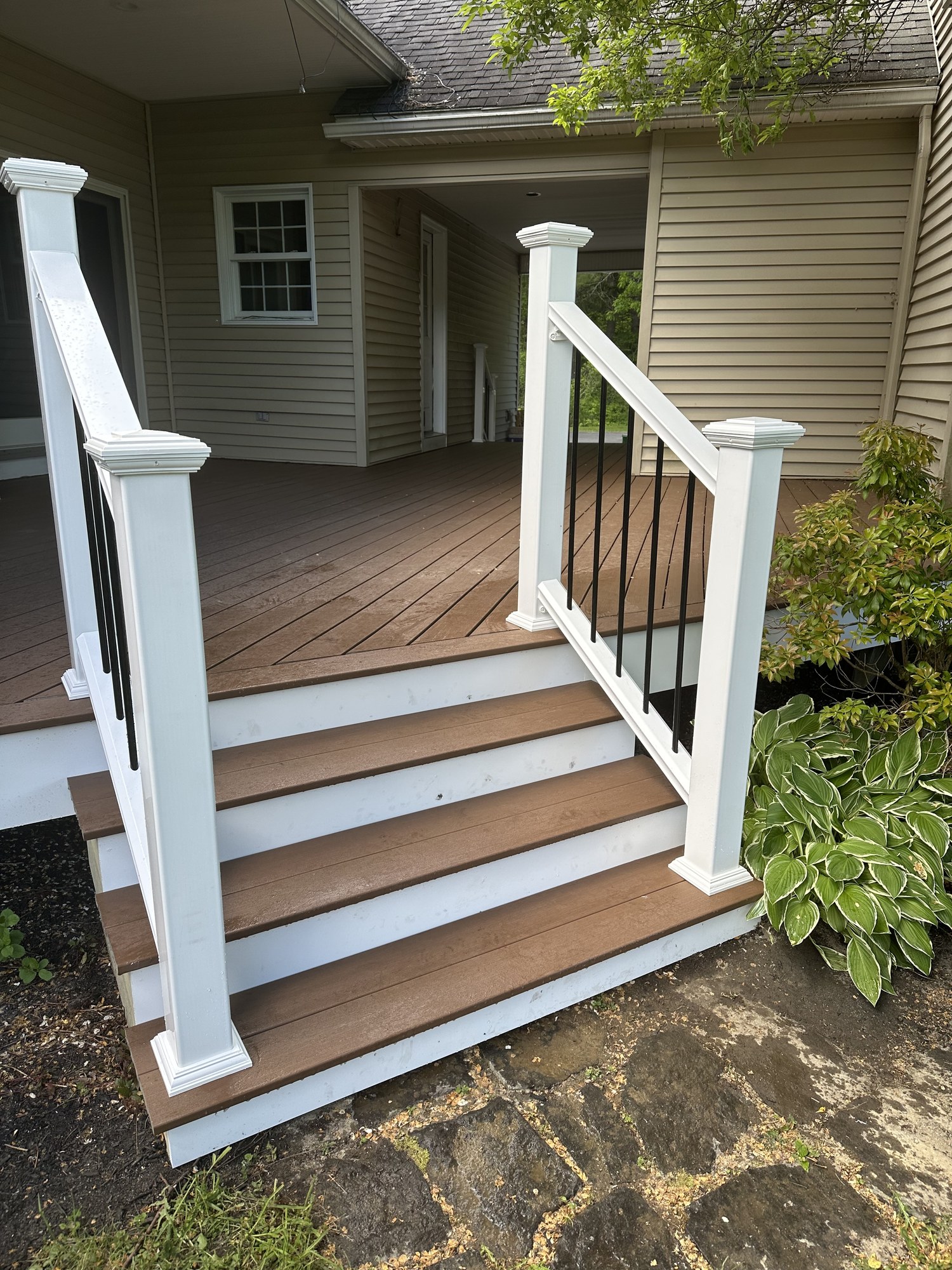 Finished deck stairs with white railings