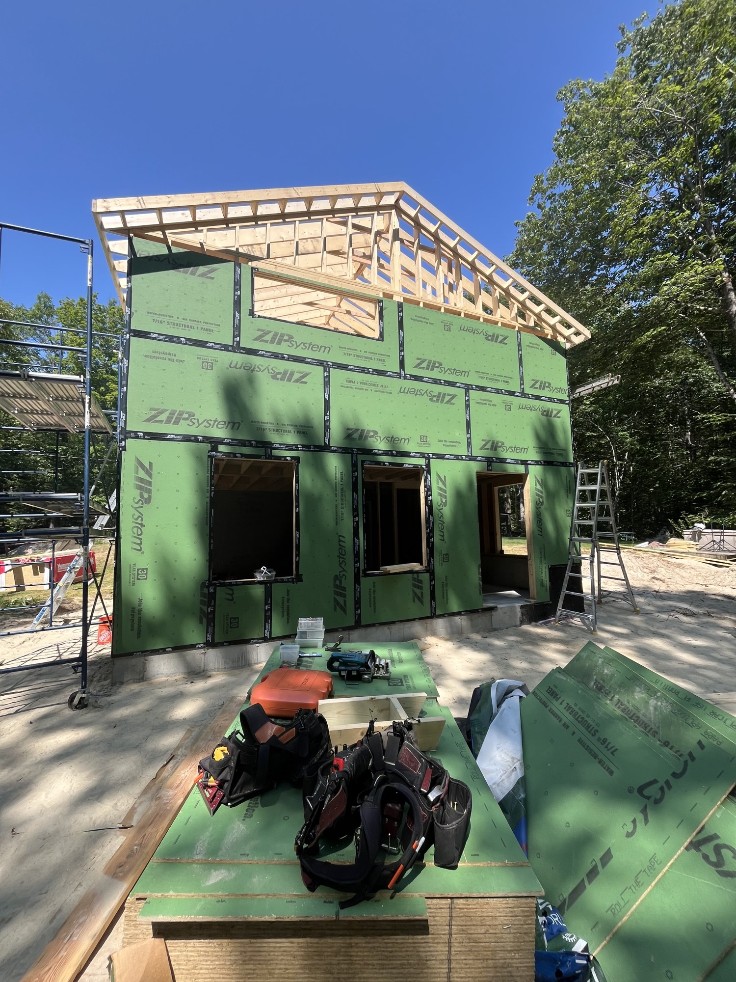 Framed addition with roof trusses complete, tied into the existing house