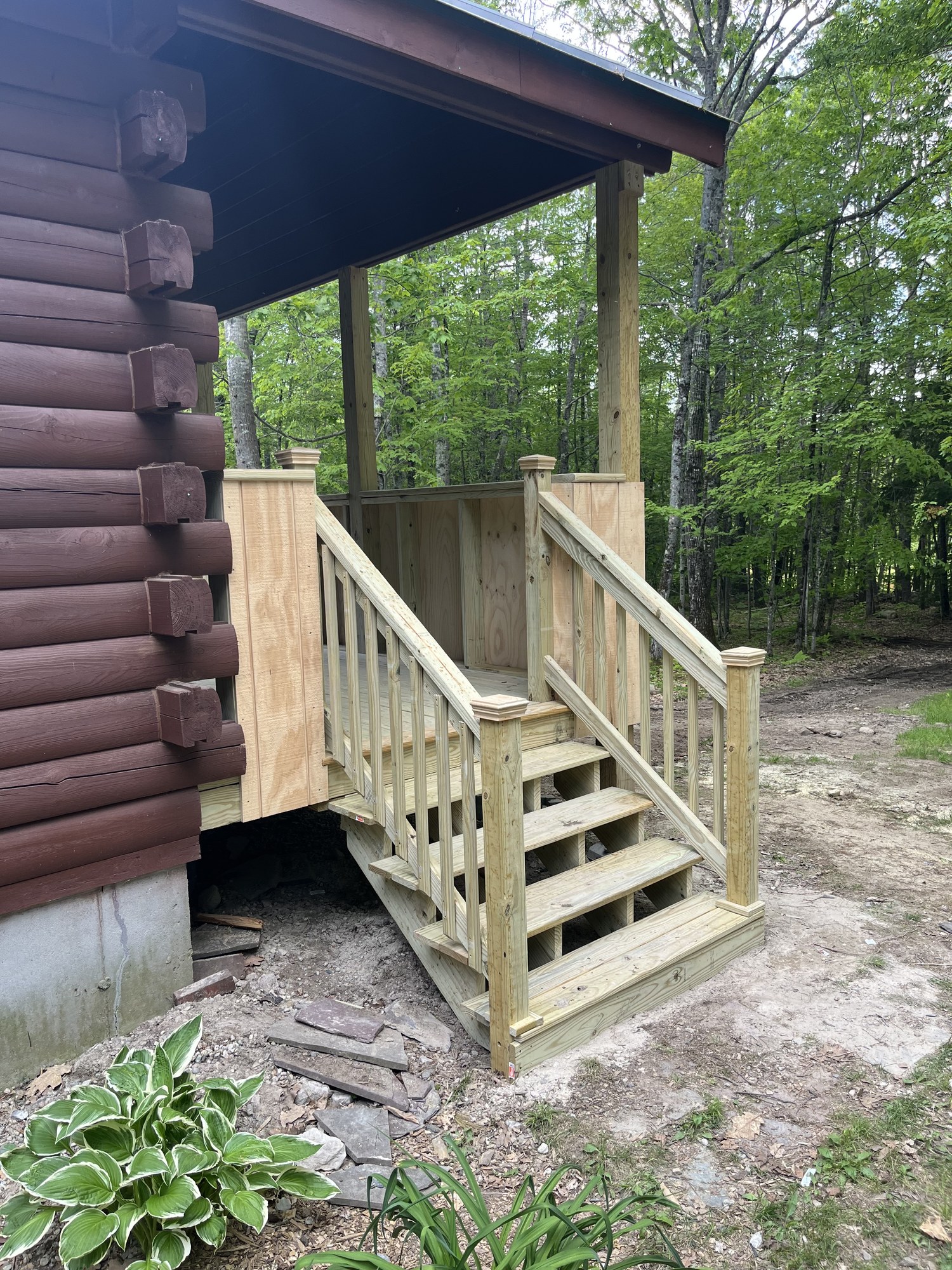 Log cabin covered porch and entry steps